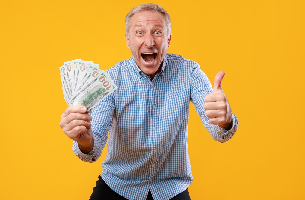 Excited Mature Man Holding a Lot of Money Cash